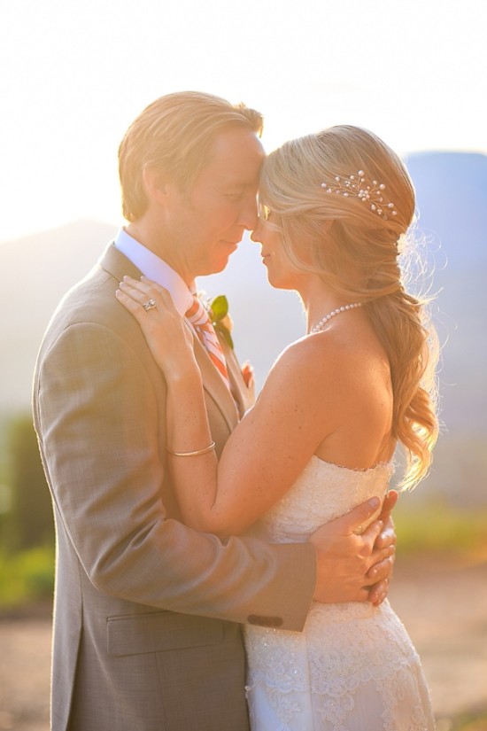 Romantic bride and groom embrace on wedding day