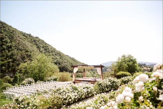 Romantic white flower hillside wedding ceremony stage