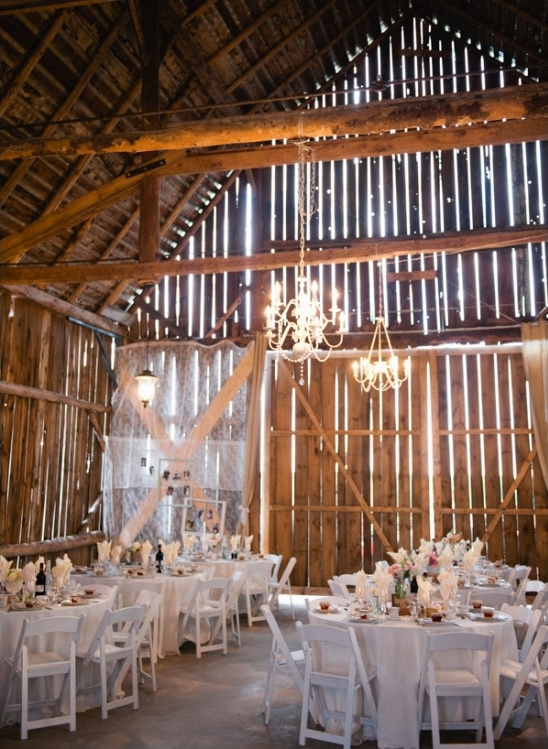 barn reception lit by chandelieres