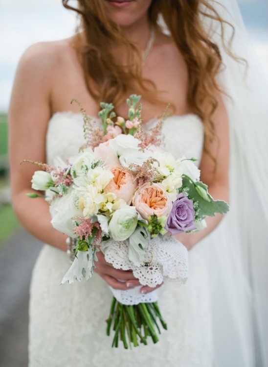 peach yellow and purple wedding bouquet wrapped in lace