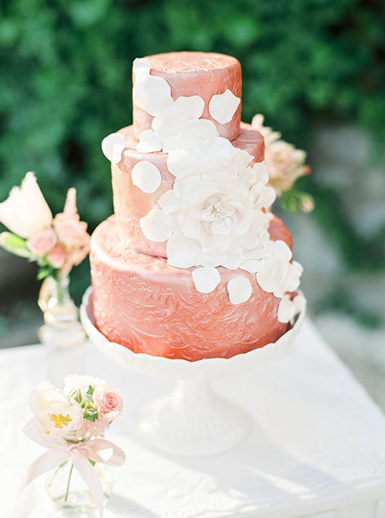dark blush wedding cake with cascading petals