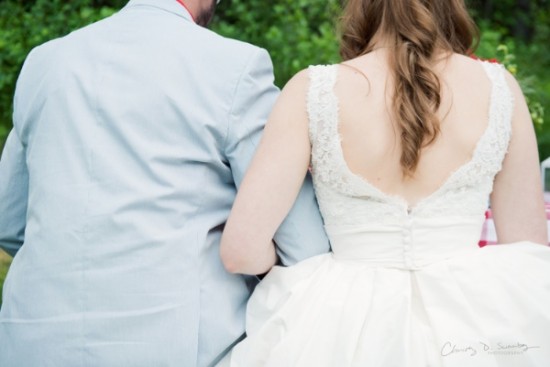 Wedding bride in white lace dress and groom back view