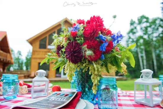 Table setting with flowers in mason jars at wedding