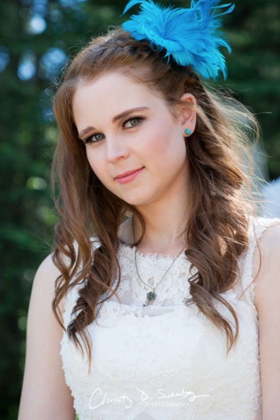Smiling woman with blue feather and braided hair