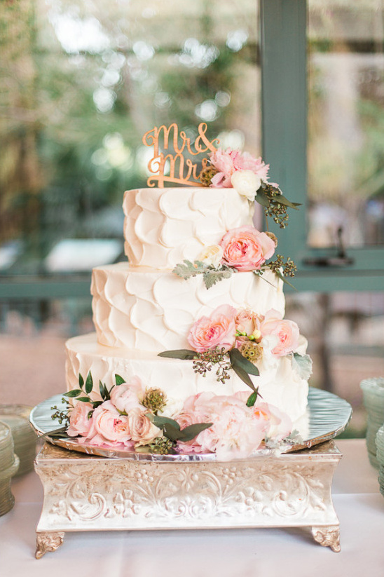 gorgeous white wedding cake with pink floral decor