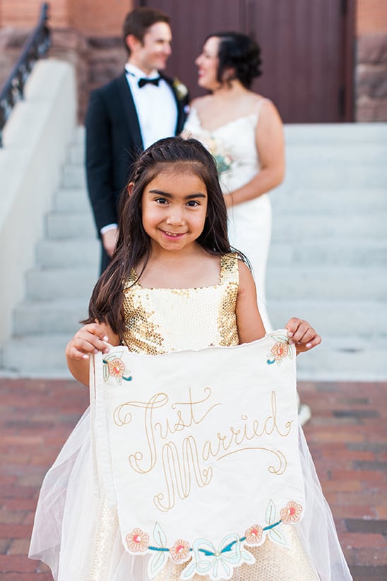 flower girl with just married banner