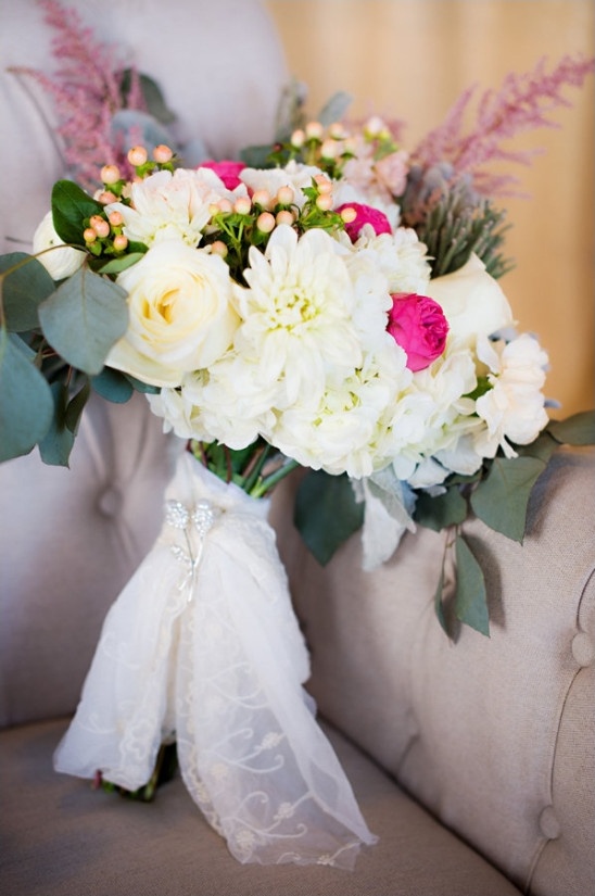white and pink wedding bouquet wrapped in lace