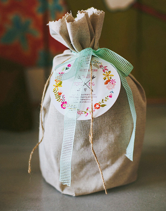 Burlap gift bag with floral tag and light blue ribbon