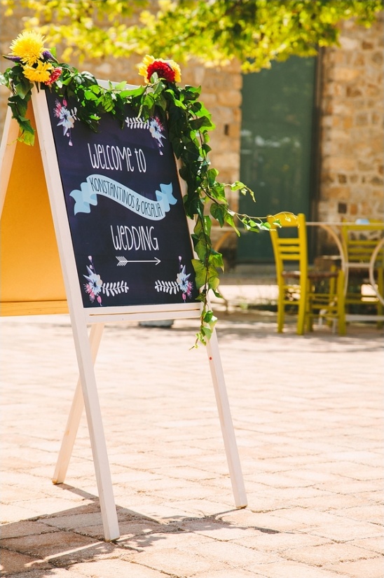 Konstantinos and Orsalia wedding chalkboard sign flowers