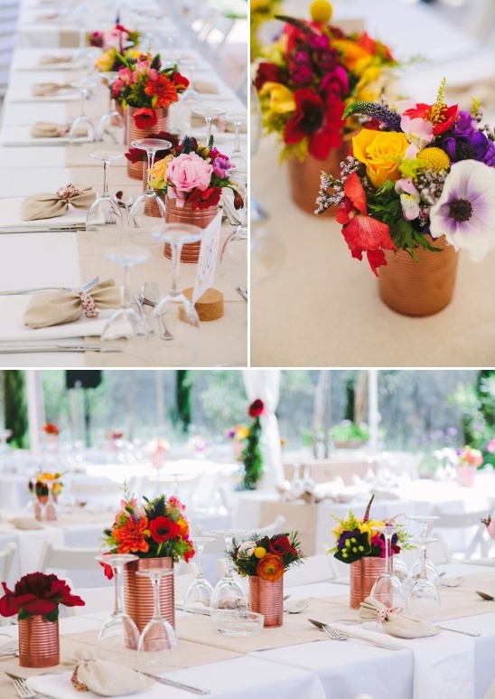 Festive wedding reception table decor flowers in tin cans