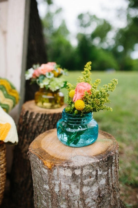 mini flower arrangements in fun colored jars