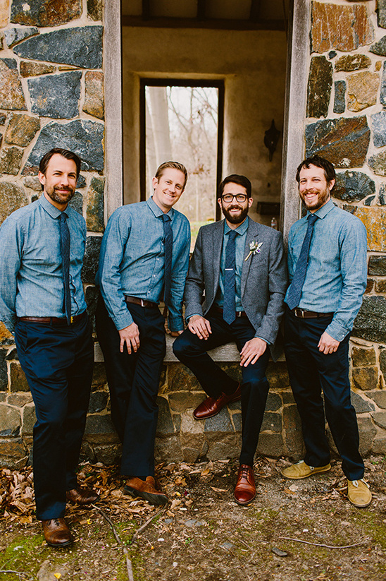 Groomsmen in blue shirts at rustic outdoor wedding
