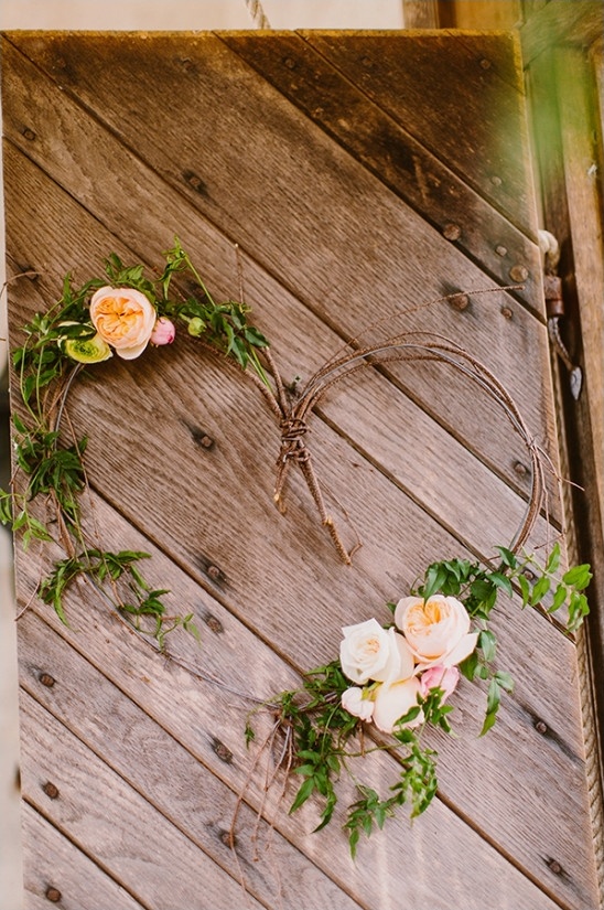 Rustic wooden door with heart shaped floral wreath