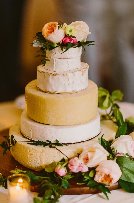 Three tier cheese wheel cake with floral decorations