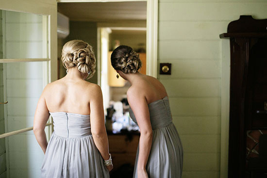 Bridesmaids in grey dresses with elaborate hairstyles