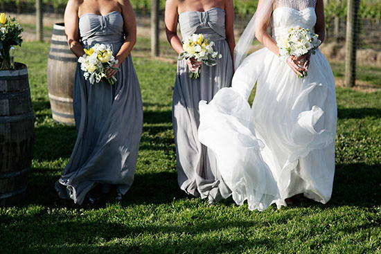 Bride and bridesmaids in gray dresses with bouquets