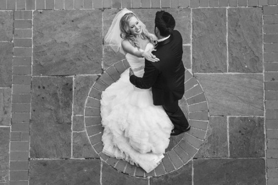 Bride and groom share first dance black and white photo