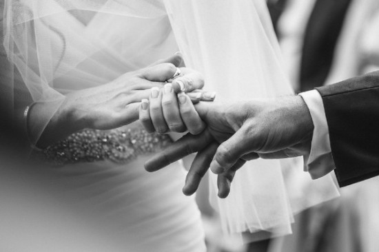 Bride and groom holding hands wedding rings on fingers