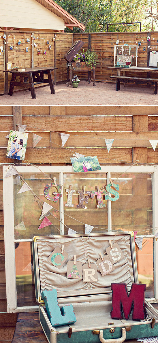 Rustic outdoor wedding decor with bunting and vintage suitcase