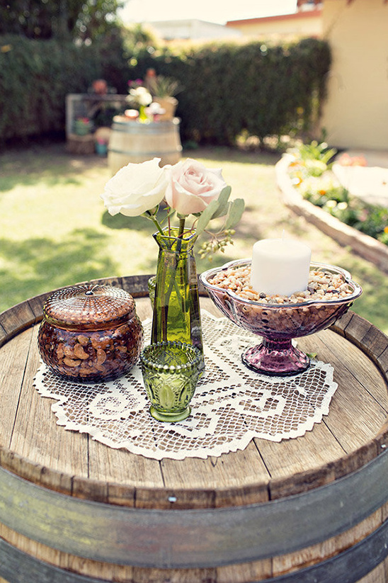 Charming rustic wedding decor on wine barrel table