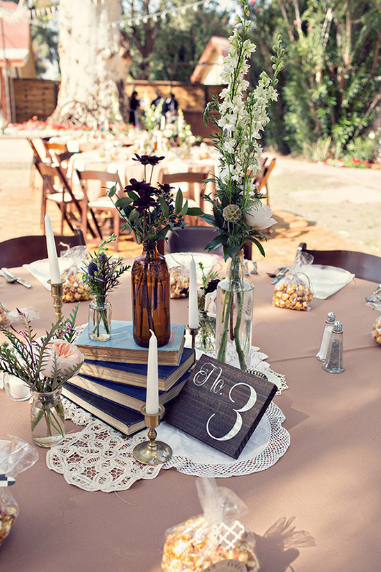 Rustic wedding table centerpiece with books and flowers