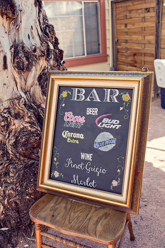Chalkboard sign advertising beer and wine at a bar