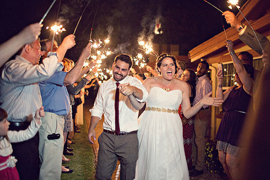Bride and groom exit with sparklers at wedding reception