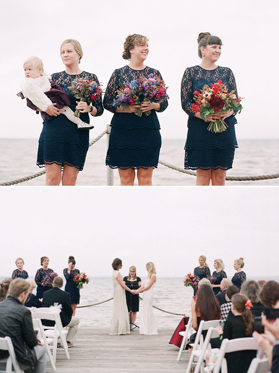 Bridesmaids in navy at joyful outdoor pier wedding ceremony
