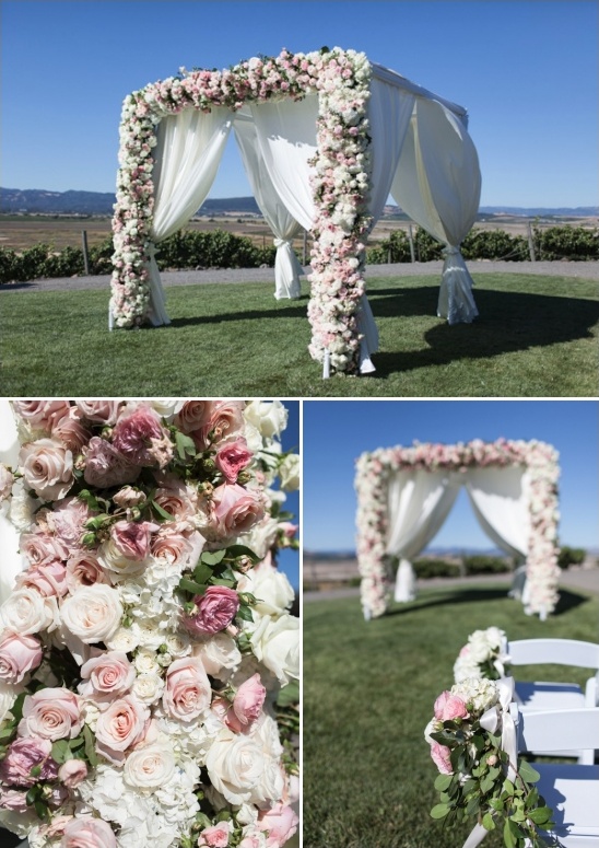 pink and white rose covered wedding arch