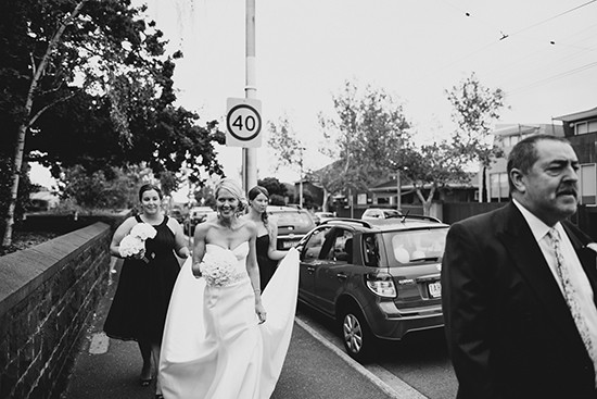 Black and white photo of bride and wedding party outdoors