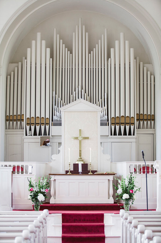 Church interior featuring a large pipe organ and altar