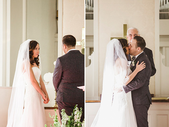Bride and groom share first kiss at church wedding