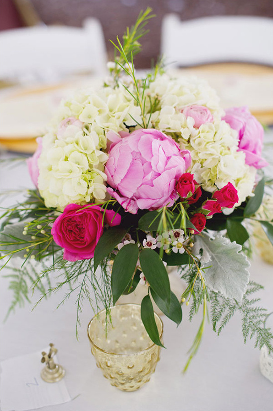 Pink and white floral centerpiece on wedding table