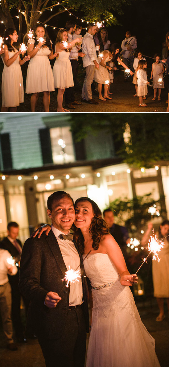 Bride and groom celebrate with sparklers and guests