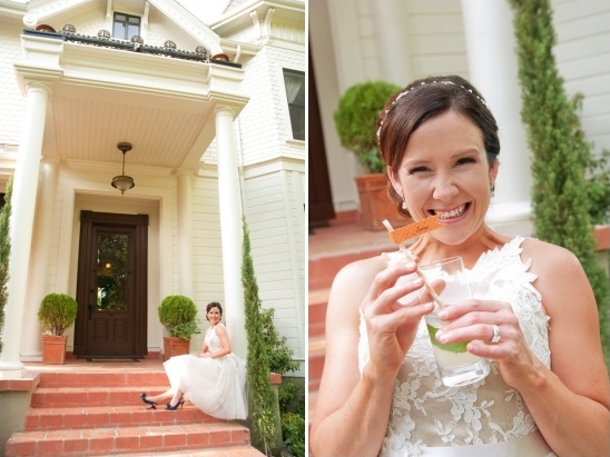 Smiling bride smiles with drink at wedding house venue