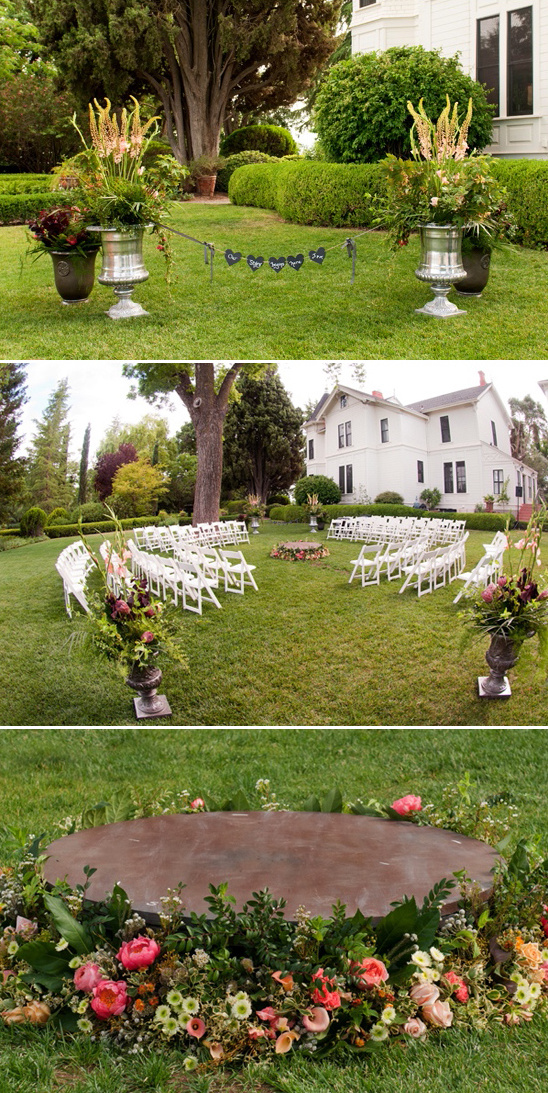 Garden wedding ceremony with floral stage and chair setup