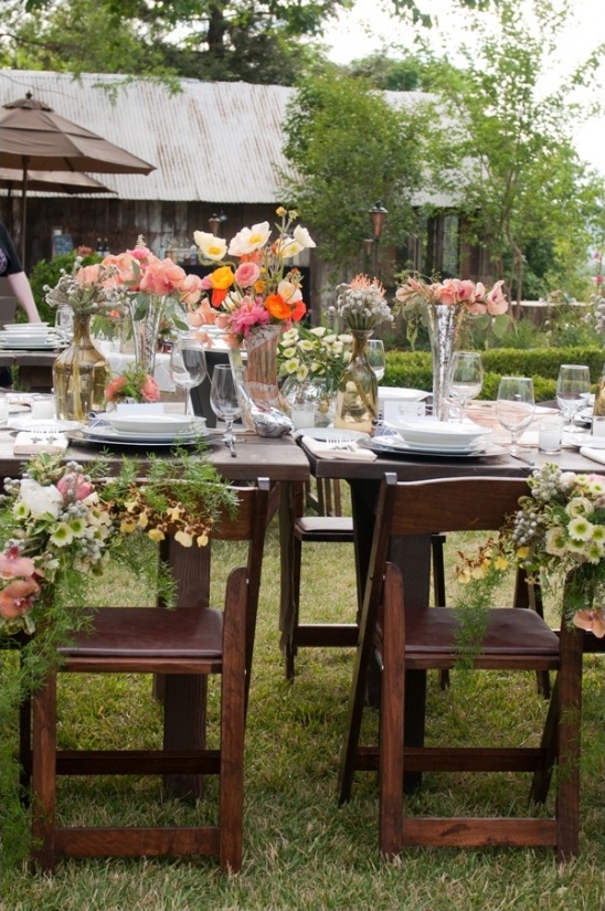 Rustic outdoor wedding table with floral centerpieces