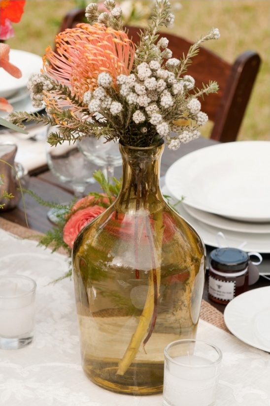 Orange and white flowers in brown vase centerpiece
