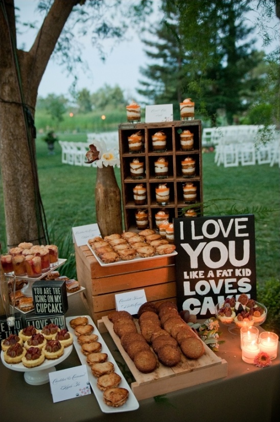 Outdoor wedding dessert table with cupcakes cookies cake sign