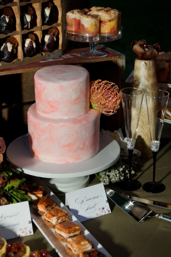 Elegant wedding dessert table with pink marbled cake