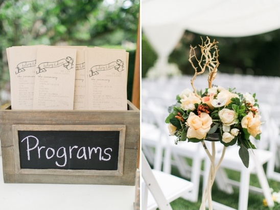 Wedding programs in box and floral arrangement aisle decor