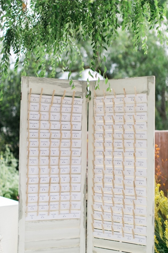 Rustic wedding seating chart on repurposed shutter doors