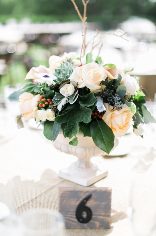 Elegant floral centerpiece at table number six wedding