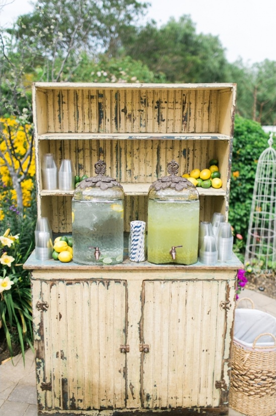 Rustic lemonade stand with beverages and cups outdoors
