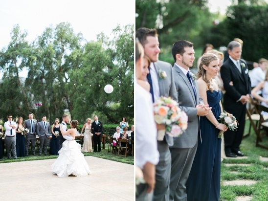Wedding guests watch the first dance of the newlyweds