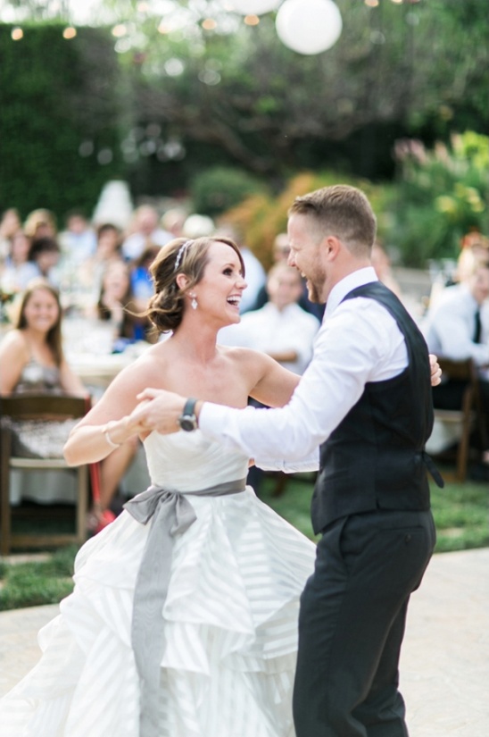 Bride and groom share first dance at outdoor wedding