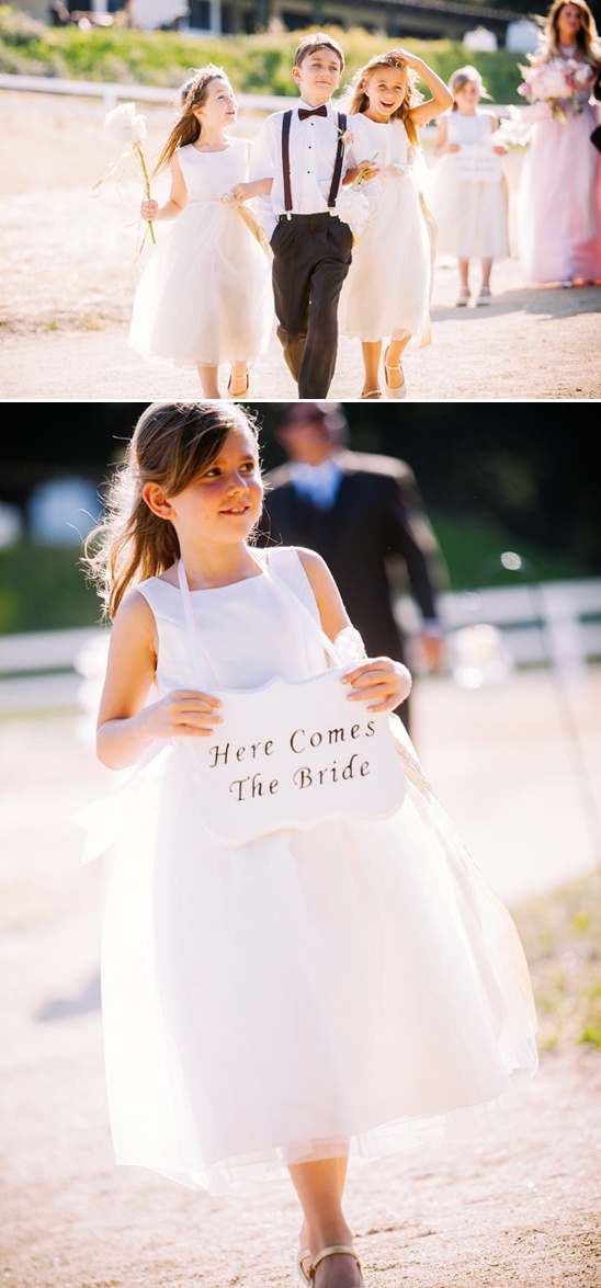 cute ring bearer with two flower girls and here comes the bride sign