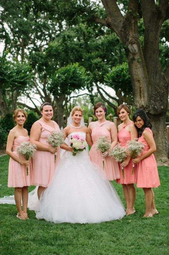 Bride and bridesmaids in pink dresses at outdoor wedding