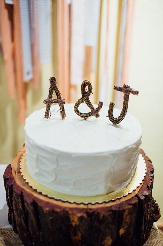 simple wedding cake with cute wooden cake topper