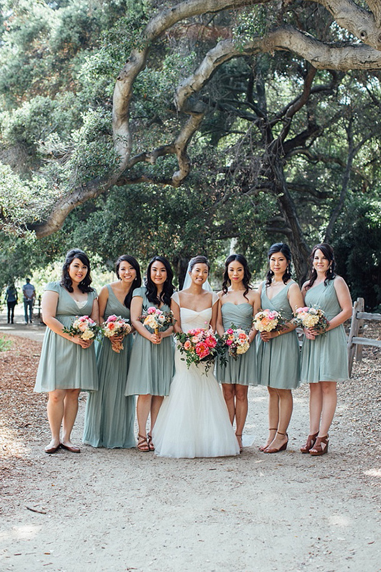 Bride and bridesmaids in green dresses outdoor wedding